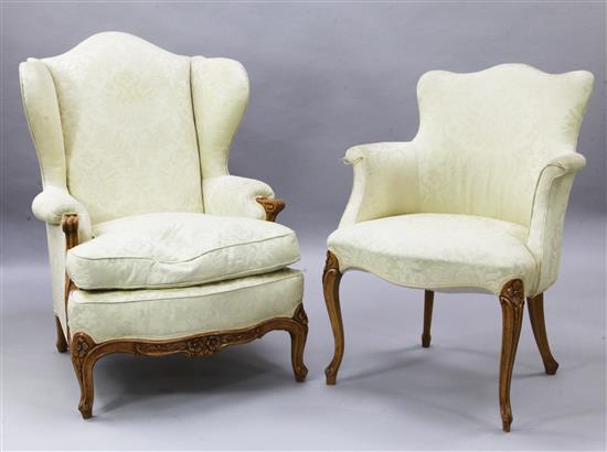 A French carved beech wing armchair and a matching armchair,